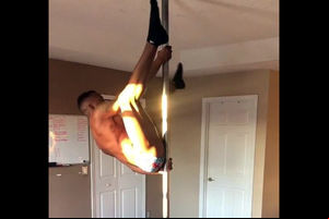 Dark-hued male stripper flipping on a